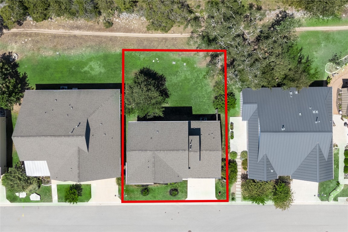 142 Volterra Lane Dripping Springs, TX 78620 - Photo 23 of 37 an aerial view of a house with a yard and a car parked