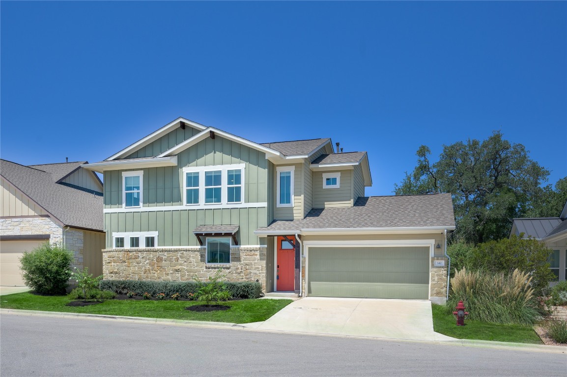 142 Volterra Lane Dripping Springs, TX 78620 - Photo 31 of 37 a front view of a house with a yard and garage