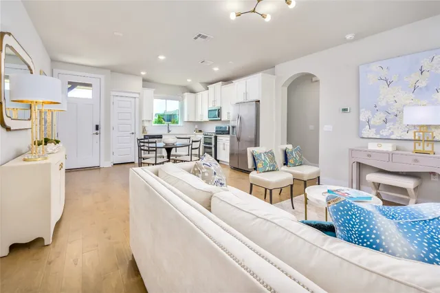 a living room with fireplace furniture and a table