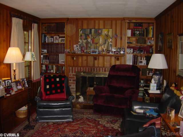 301 Ralston Road Henrico, VA 23229 - Photo 4 of 9 a living room with furniture a lamp and a fireplace