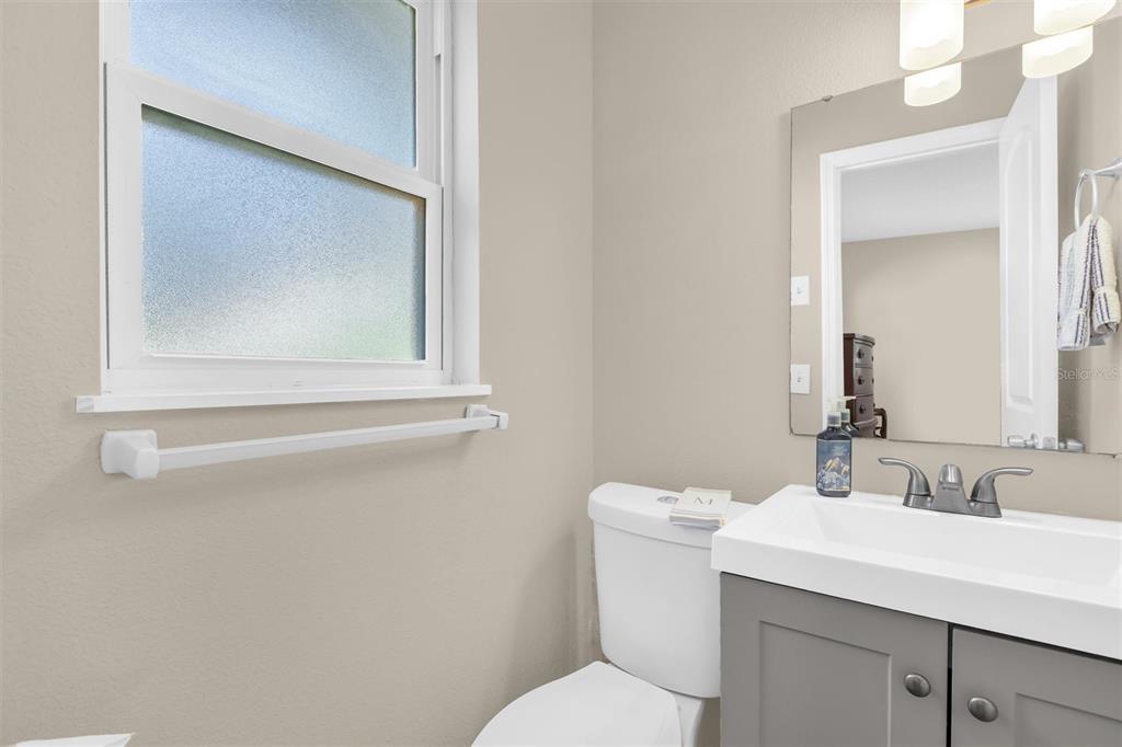 106 Oak Street Altamonte Springs, FL 32714 - Photo 13 of 30 a bathroom with a toilet sink and mirror