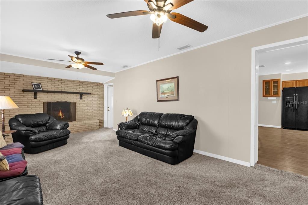 106 Oak Street Altamonte Springs, FL 32714 - Photo 4 of 30 a living room with furniture and a chandelier