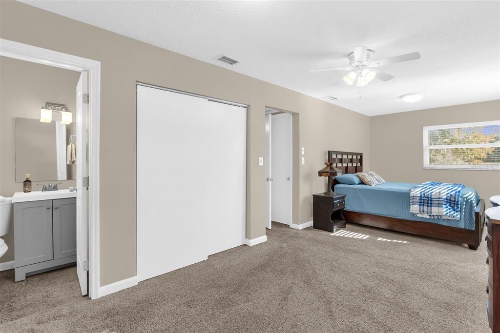 106 Oak Street Altamonte Springs, FL 32714 - Photo 9 of 30 a bedroom with a bed and a chandelier