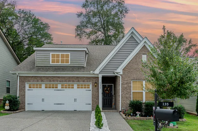 a view of house with backyard space and garden