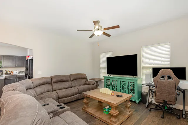a living room with furniture and a chandelier
