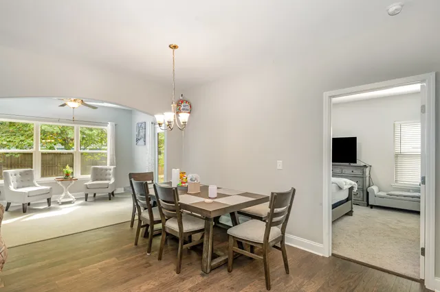 a dining room with a wooden table and chairs