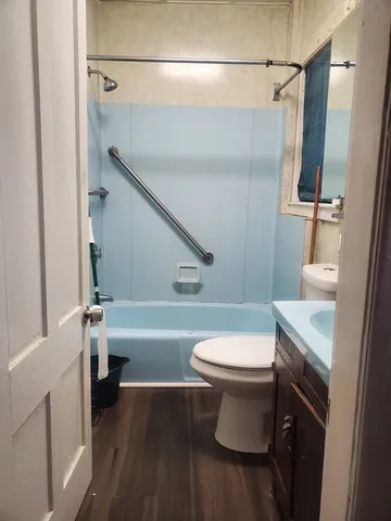 a view of walk in closet with wooden floor and cabinet