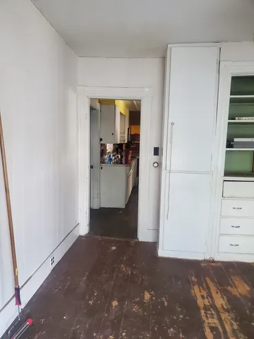 a view of a room with wooden floor