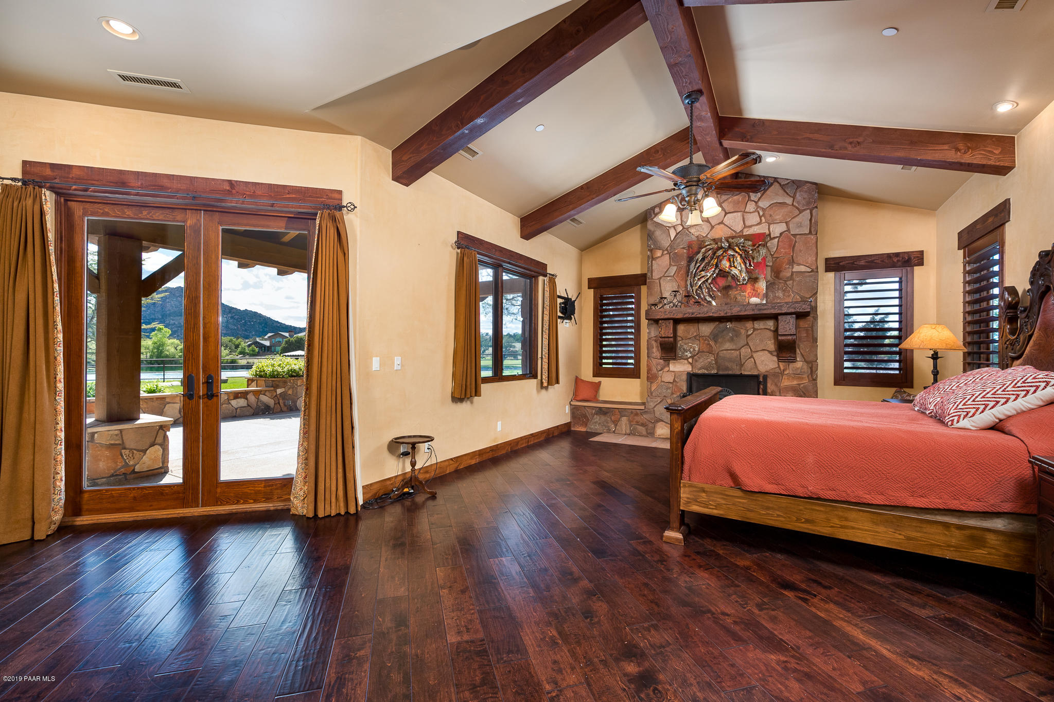 9120 North American Ranch Road Prescott, AZ 86305 - Photo 22 of 66 a spacious bedroom with a bed and wooden floor