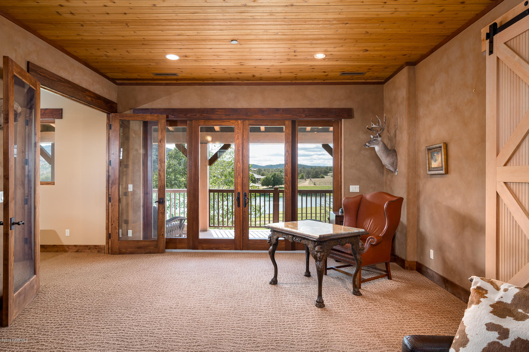 9120 North American Ranch Road Prescott, AZ 86305 - Photo 27 of 66 a living room with furniture and a floor to ceiling window