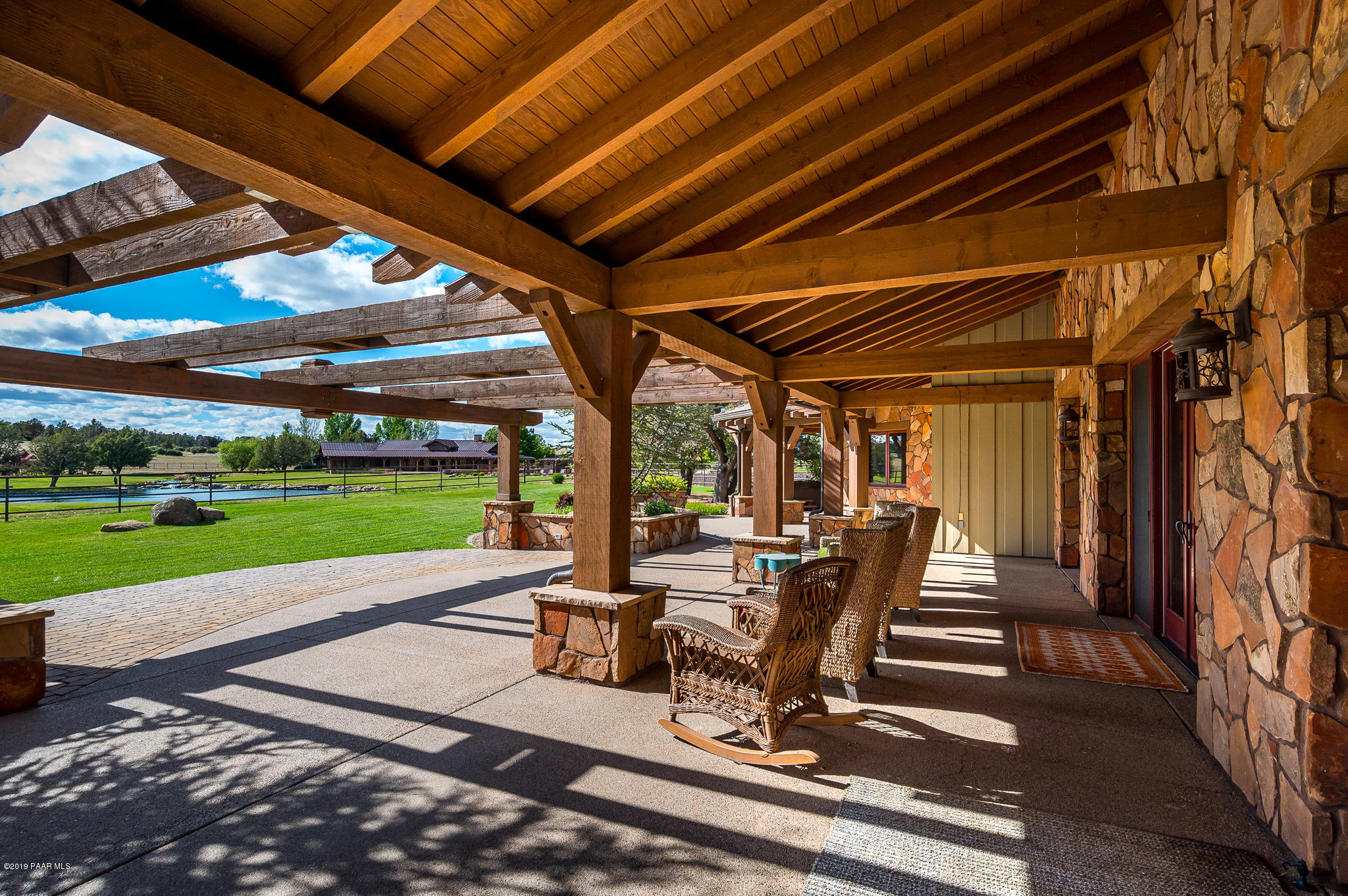 9120 North American Ranch Road Prescott, AZ 86305 - Photo 35 of 66 a view of a patio with a table chairs and a backyard