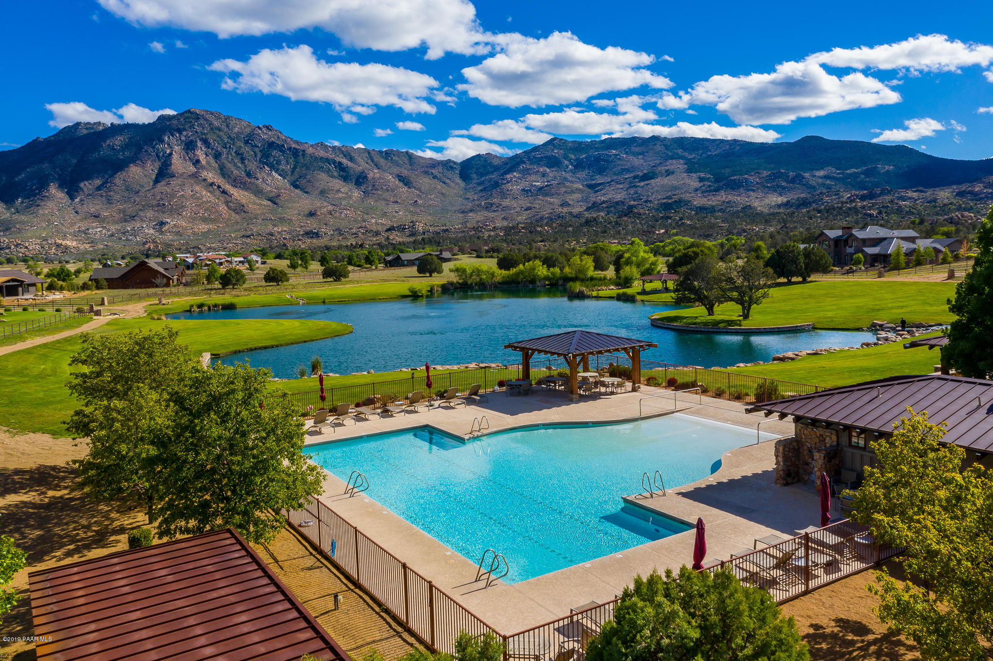 9120 North American Ranch Road Prescott, AZ 86305 - Photo 44 of 66 a view of a swimming pool with an outdoor seating and a garden