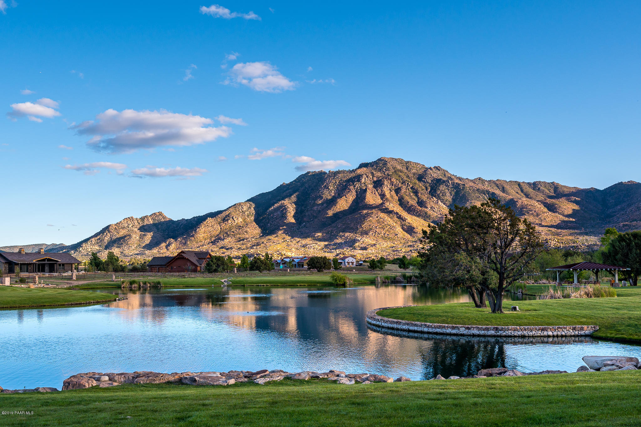 9120 North American Ranch Road Prescott, AZ 86305 - Photo 48 of 66 a view of a lake with a house in the background