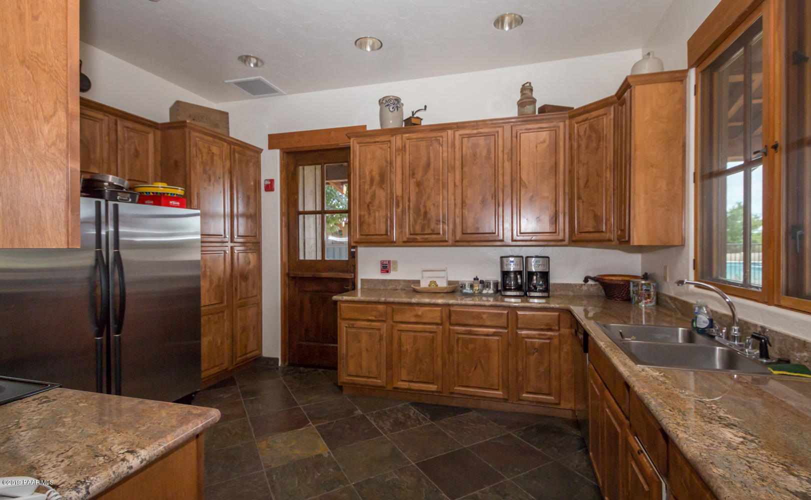 9120 North American Ranch Road Prescott, AZ 86305 - Photo 54 of 66 a kitchen with stainless steel appliances granite countertop a refrigerator a sink and a stove