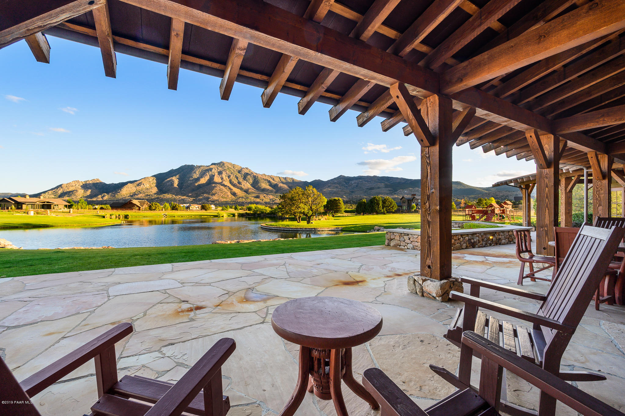 9120 North American Ranch Road Prescott, AZ 86305 - Photo 56 of 66 a view of a chairs and table in patio with a yard
