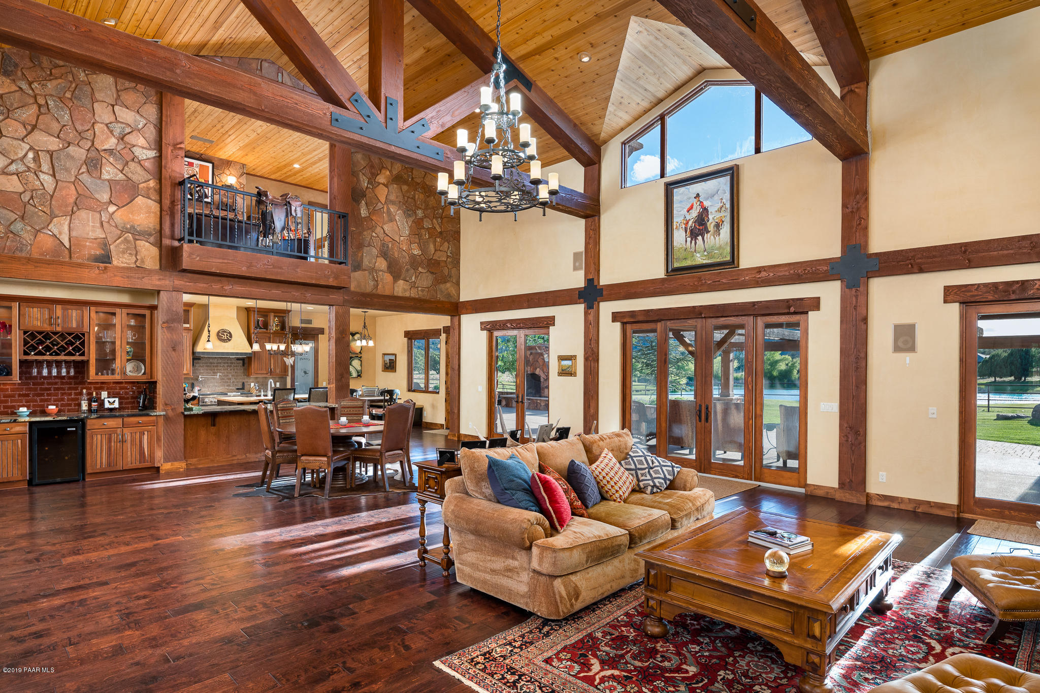 9120 North American Ranch Road Prescott, AZ 86305 - Photo 8 of 66 a living room with furniture a rug and a chandelier