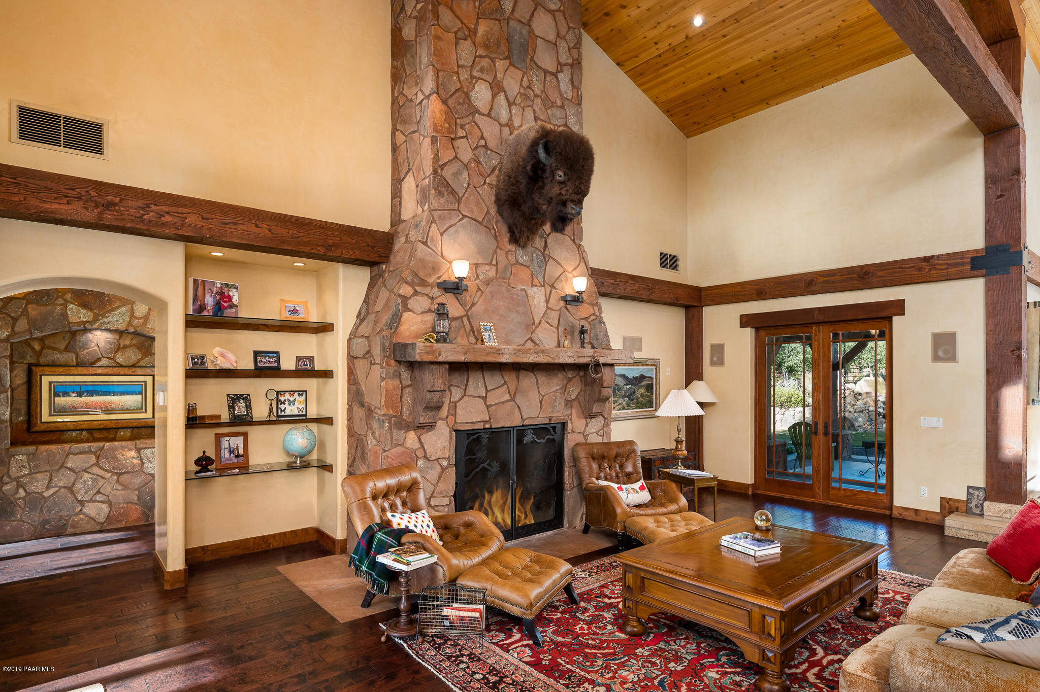 9120 North American Ranch Road Prescott, AZ 86305 - Photo 10 of 66 a living room with furniture a fireplace and a table