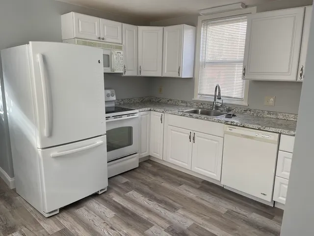 a white refrigerator freezer sitting inside of a kitchen