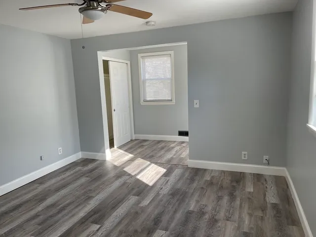 wooden floor in an empty room with a window