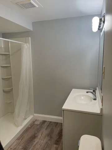 a bathroom with a sink toilet and shower