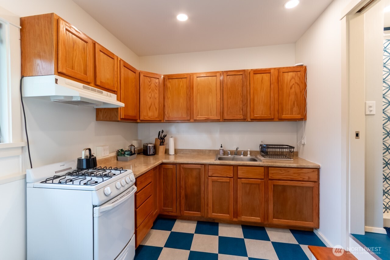 63 East Arnette Road Port Angeles, WA 98362 - Photo 36 of 40 a kitchen with stainless steel appliances a stove a sink and a refrigerator