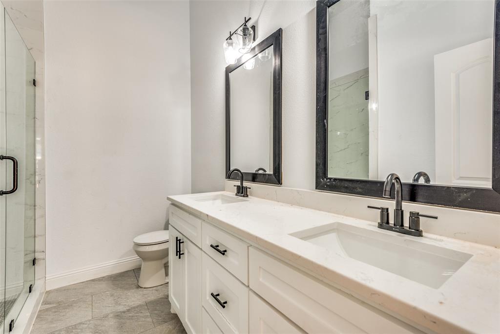 1563 Milam Street Fort Worth, TX 76112 - Photo 11 of 12 Full bath with a marble finish shower, double vanity, and light tile patterned flooring