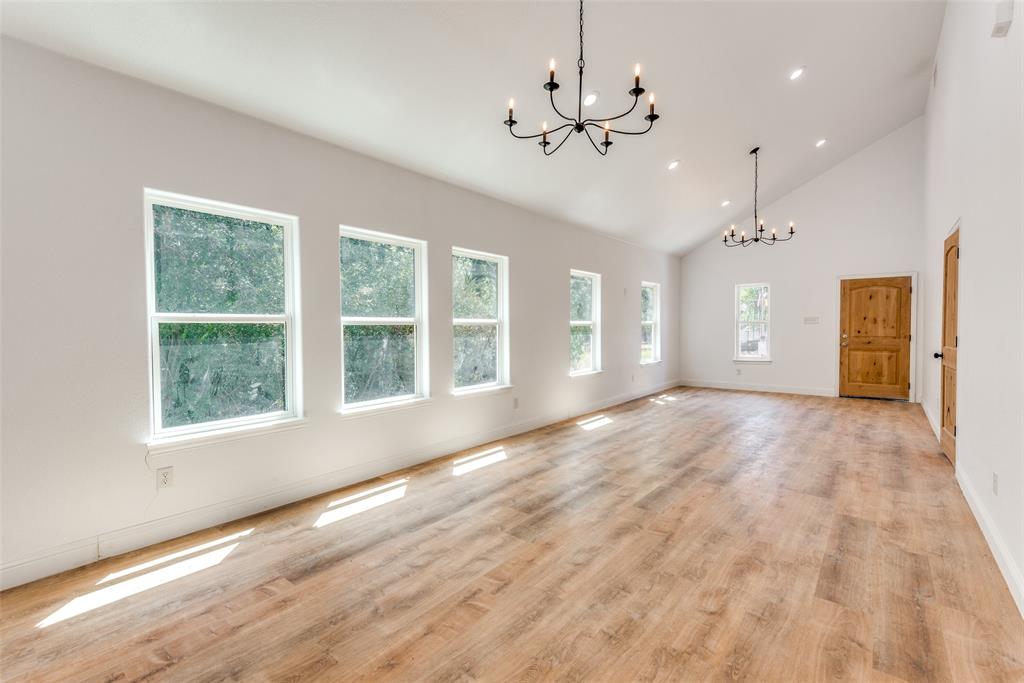 1563 Milam Street Fort Worth, TX 76112 - Photo 4 of 12 Unfurnished dining area with high vaulted ceiling, a chandelier, light wood-style floors, and recessed lighting