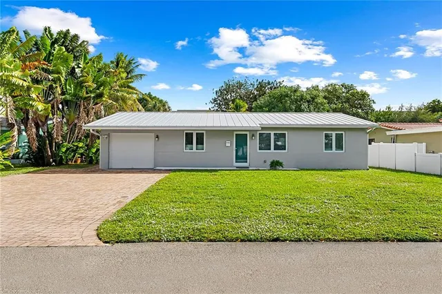 a view of a house with a backyard