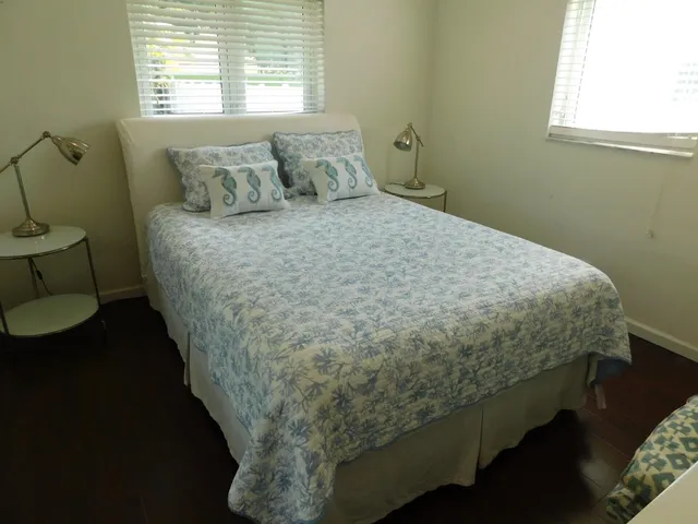 a bed sitting in a bedroom next to a window