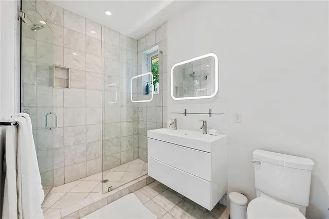 a bathroom with a toilet sink and shower