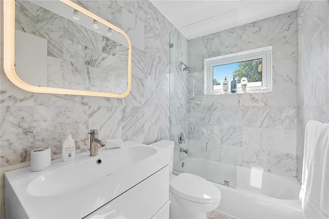 a bathroom with a sink a mirror and a bathtub