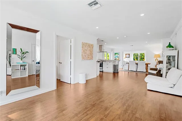 a view of a living room kitchen and a wooden floor