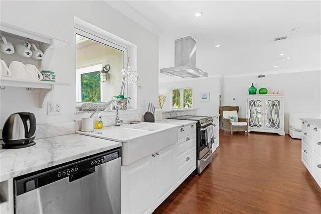 a kitchen with a sink a stove and cabinets