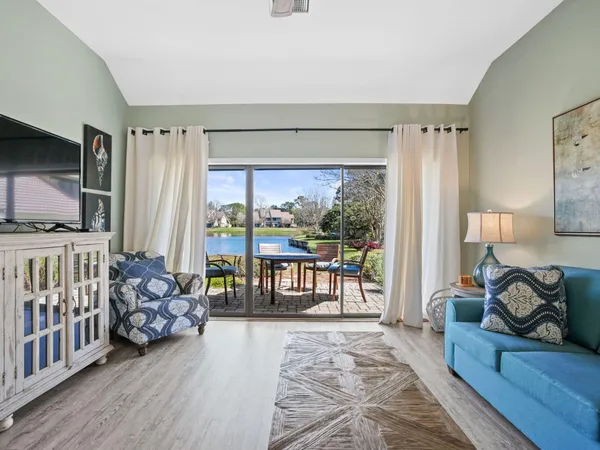 a bedroom with furniture and a large window