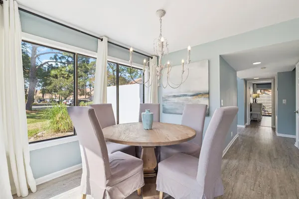 a view of a dining room with furniture window and wooden floor