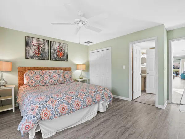 a bedroom with a large bed and a chandelier