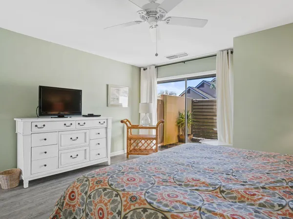 a bedroom with a bed and flat screen tv