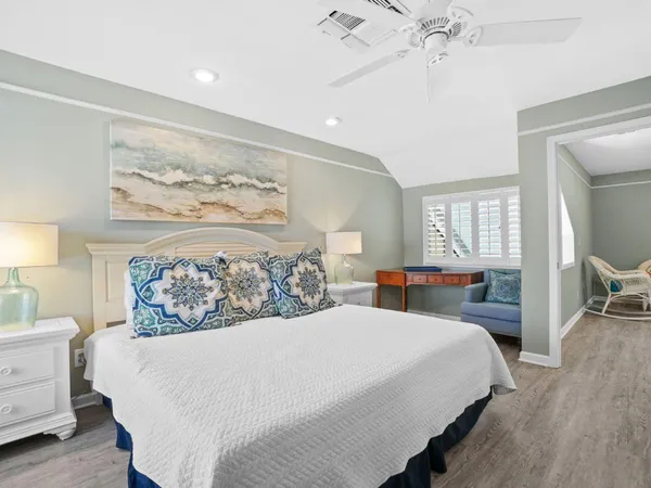 a bedroom with a large bed and a chandelier