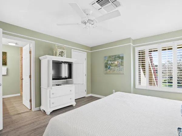 a bedroom with furniture and flat screen tv