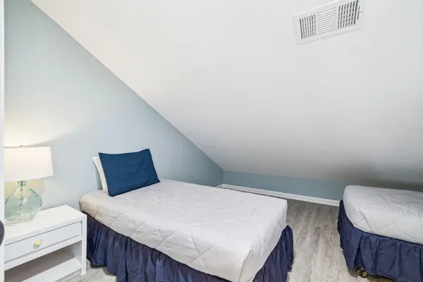 a bedroom with a bed and a chair