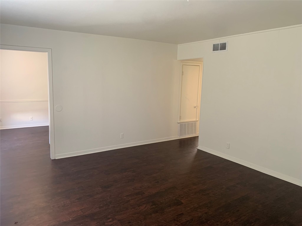 1918 Hearthstone Drive, Unit 102 Austin, TX 78758 - Photo 1 of 1 an empty room with wooden floor and windows
