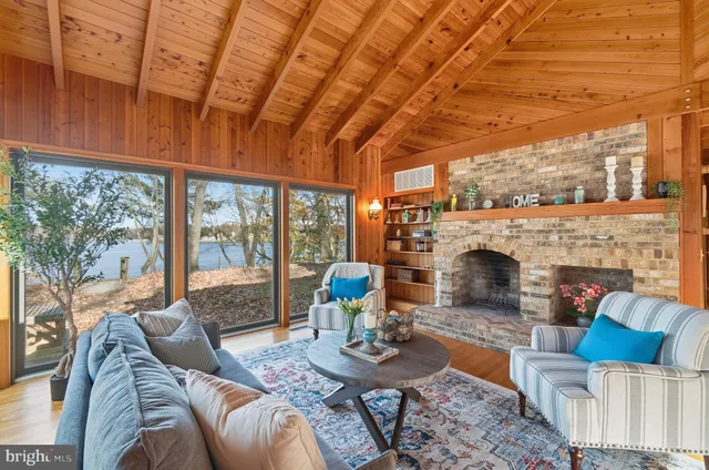 a living room with furniture a fireplace and a table