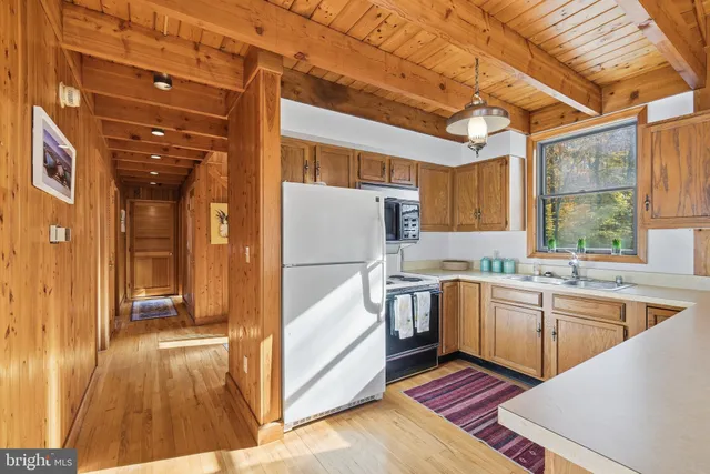 a kitchen with stainless steel appliances granite countertop a sink and cabinets