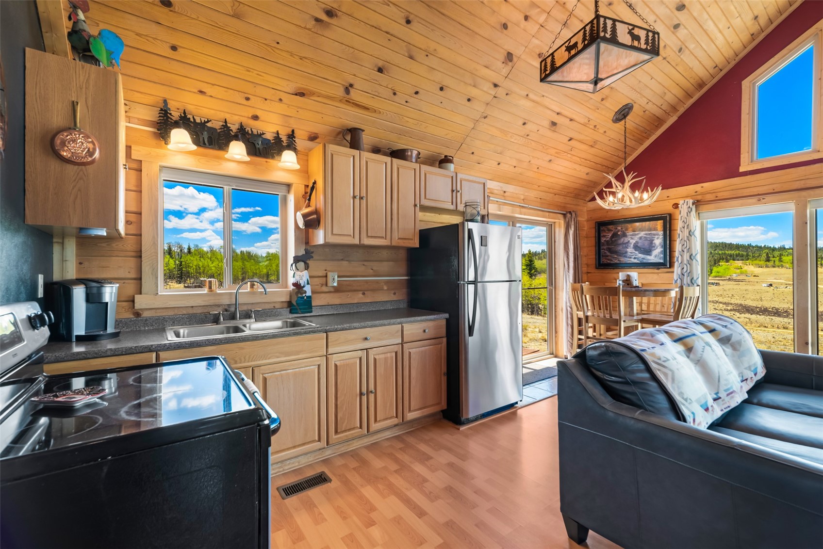 15 Mallard Road Como, CO 80432 - Photo 4 of 49 a kitchen with stainless steel appliances granite countertop a refrigerator a sink dishwasher a stove and a dining table with wooden floor