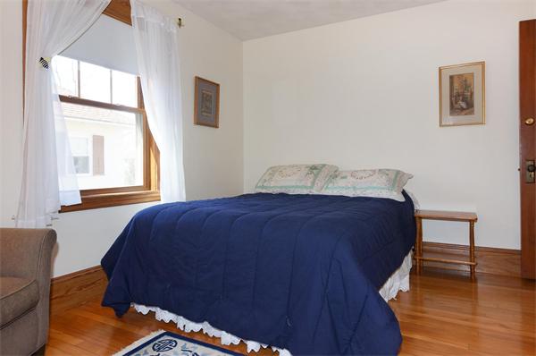 26 Jackson Road Medford, MA 02155 - Photo 12 of 25 a bedroom with a bed and wooden floor