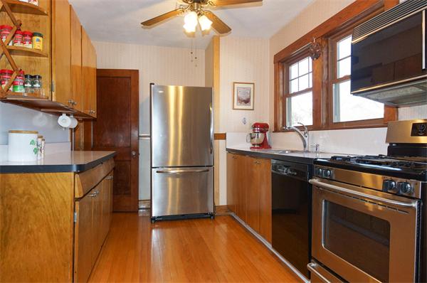 26 Jackson Road Medford, MA 02155 - Photo 6 of 25 a kitchen with stainless steel appliances granite countertop a refrigerator a stove a sink and a microwave
