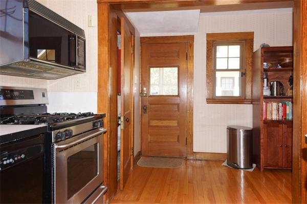 26 Jackson Road Medford, MA 02155 - Photo 7 of 25 a kitchen with stainless steel appliances granite countertop a stove and a refrigerator