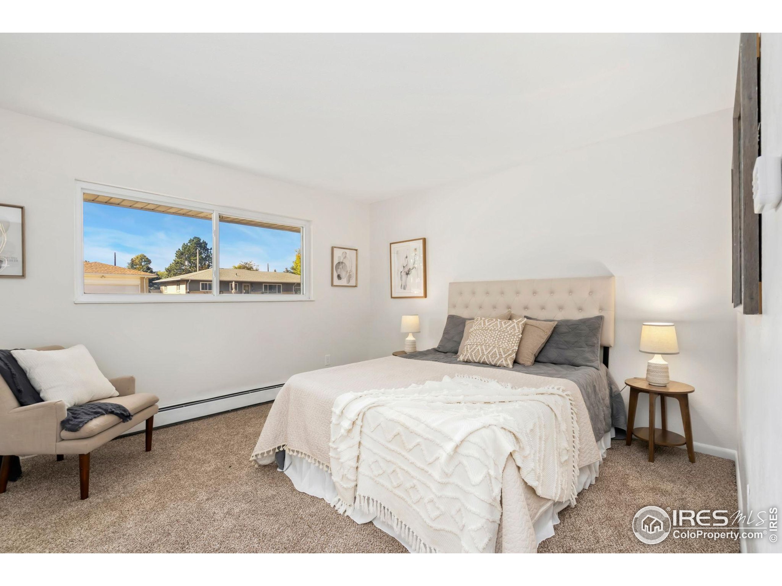 435 Birch Avenue Eaton, CO 80615 - Photo 19 of 32 a bedroom with a bed and painting on the wall