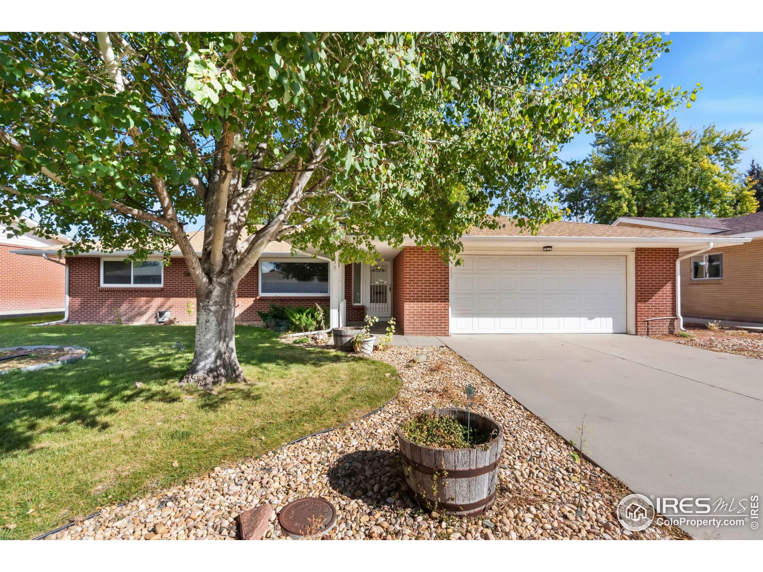 435 Birch Avenue Eaton, CO 80615 - Photo 2 of 32 a front view of a house with garden