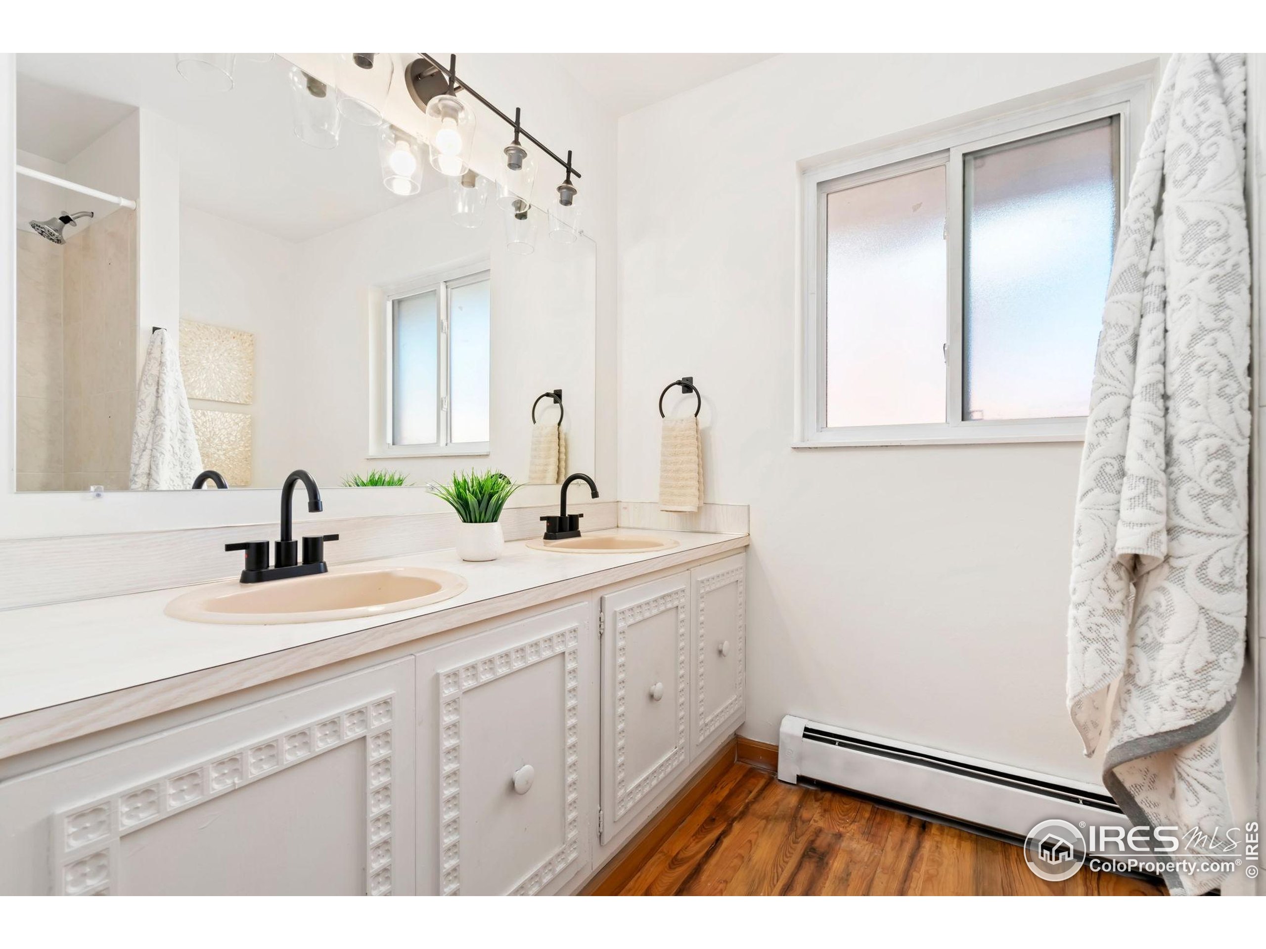 435 Birch Avenue Eaton, CO 80615 - Photo 21 of 32 a spacious bathroom with a sink a mirror and shower